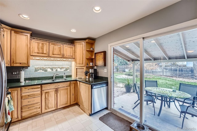 kitchen featuring dishwasher, tasteful backsplash, and sink