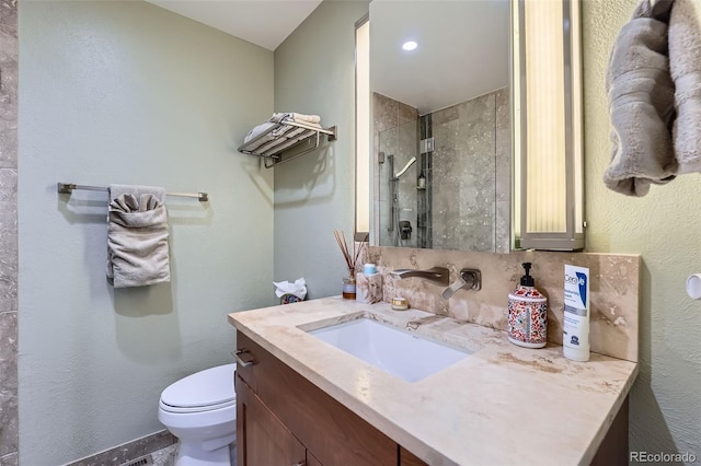 bathroom with vanity, toilet, and a shower with shower door