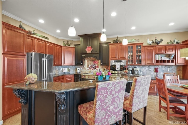 kitchen featuring pendant lighting, stainless steel appliances, and a kitchen island