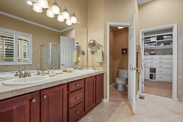 bathroom featuring crown molding, vanity, tile patterned floors, toilet, and walk in shower