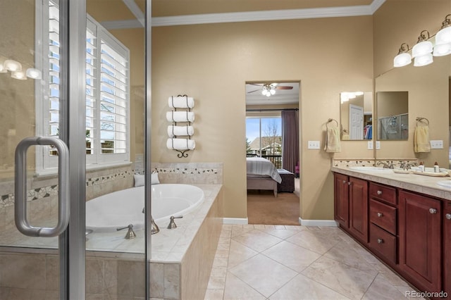 bathroom with tiled tub, ornamental molding, tile patterned floors, and vanity