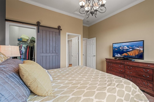 bedroom with crown molding, a barn door, a spacious closet, a closet, and a chandelier