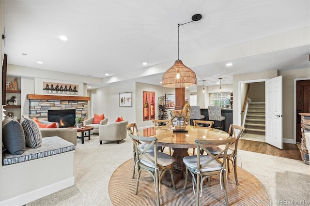 carpeted dining area featuring a fireplace