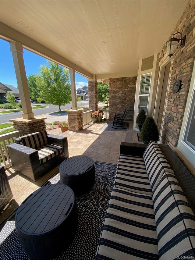 view of patio with an outdoor hangout area and covered porch