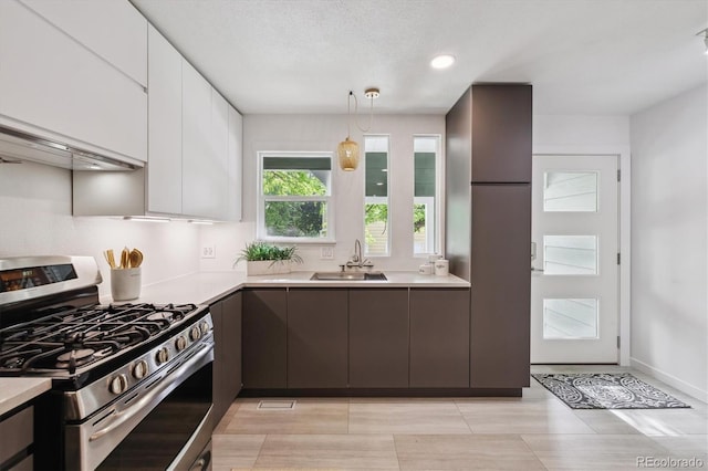 2059 S Balsam St, Lakewood, CO 80227 - kitchen featuring stainless steel range with gas stovetop, a sink, light countertops, white cabinetry, and modern cabinets