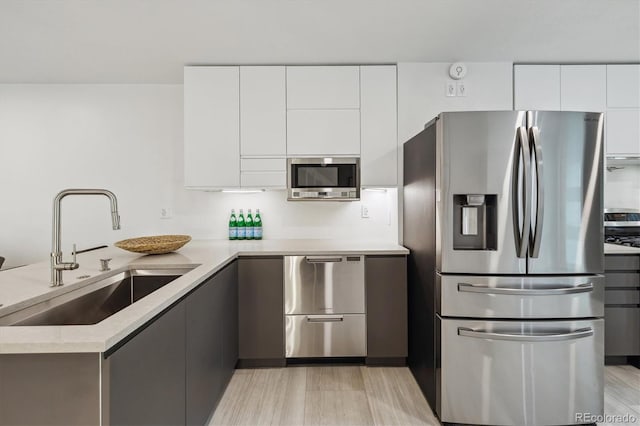 2059 S Balsam St, Lakewood, CO 80227 - kitchen featuring stainless steel appliances, a sink, modern cabinets, and white cabinetry