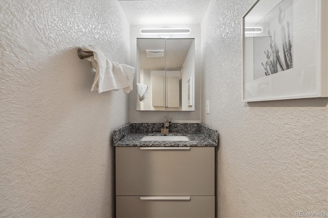 2059 S Balsam St, Lakewood, CO 80227 - bathroom with a textured wall, vanity, and a textured ceiling