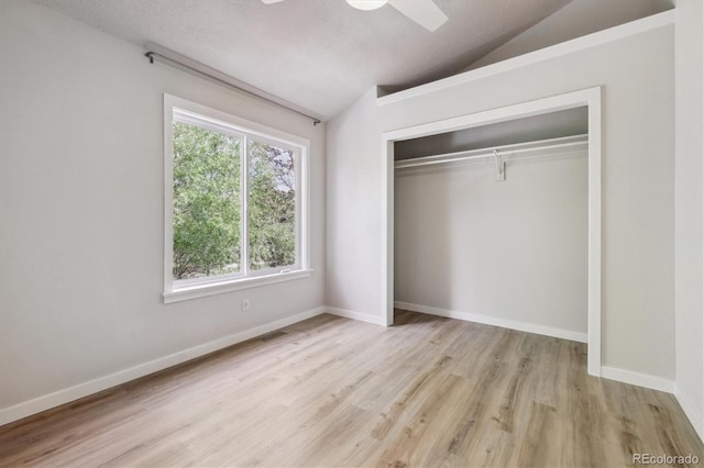 2059 S Balsam St, Lakewood, CO 80227 - unfurnished bedroom with lofted ceiling, wood finished floors, a closet, baseboards, and a ceiling fan