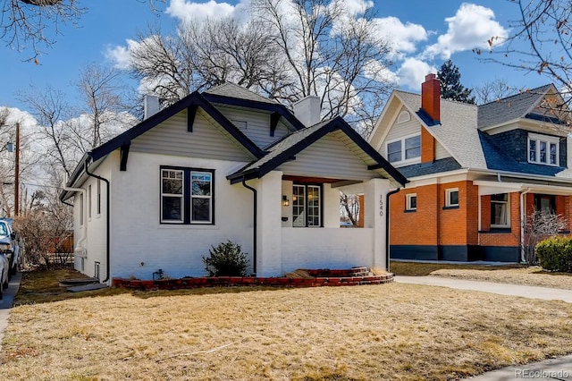 bungalow with brick siding and a chimney