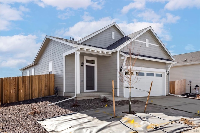 9376 Yampa Ct, Commerce City, CO 80022 - view of front of home featuring fence, a garage, and concrete driveway