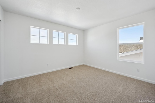 unfurnished room with carpet floors