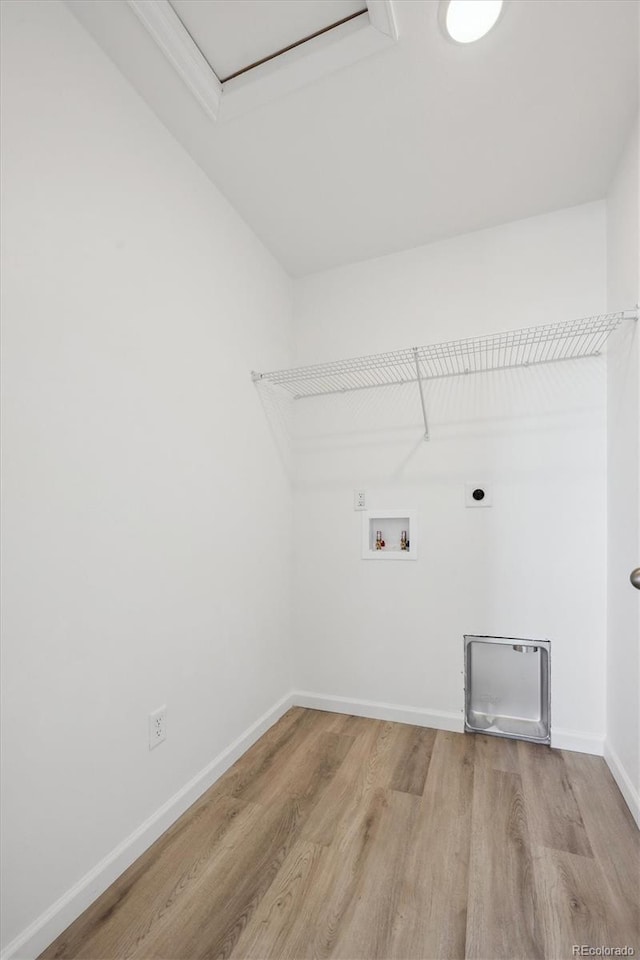 washroom with light hardwood / wood-style floors, hookup for a washing machine, and electric dryer hookup