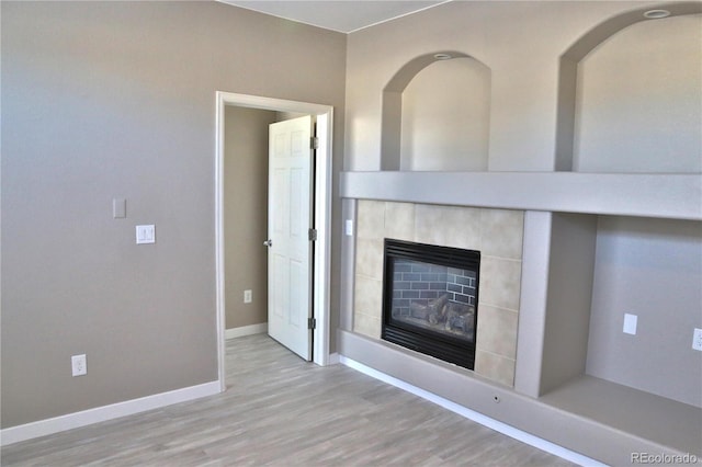 unfurnished living room featuring a fireplace and light wood-type flooring