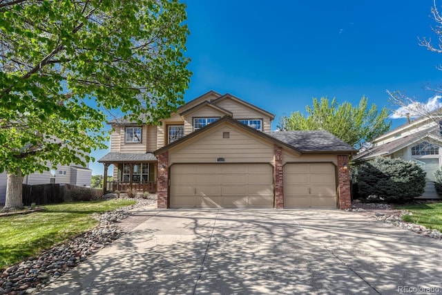 traditional home with brick siding, a garage, concrete driveway, and a front lawn