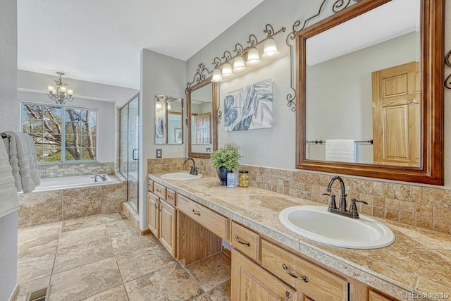 full bathroom with a chandelier, a garden tub, a stall shower, double vanity, and backsplash