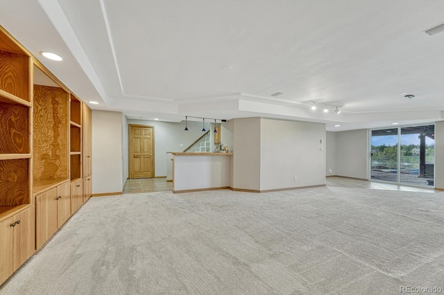 unfurnished living room featuring light carpet, baseboards, stairway, and recessed lighting