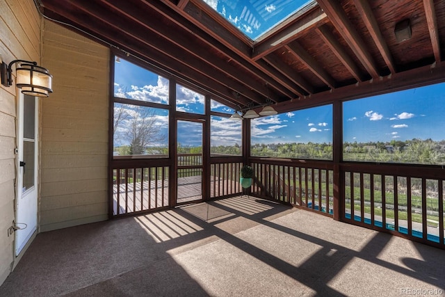 unfurnished sunroom featuring vaulted ceiling