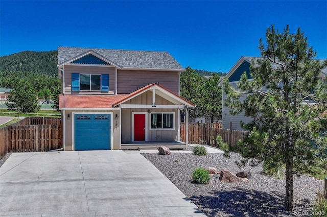 201 S Boundary St, Woodland Park, CO 80863 - view of front of home with a garage, board and batten siding, driveway, a shingled roof, and a porch