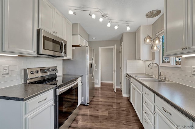201 S Boundary St, Woodland Park, CO 80863 - kitchen featuring appliances with stainless steel finishes, backsplash, dark wood-style floors, and dark countertops