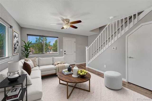 201 S Boundary St, Woodland Park, CO 80863 - living room featuring stairway, wood finished floors, a ceiling fan, and a textured ceiling