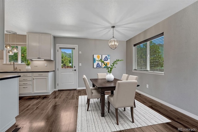 201 S Boundary St, Woodland Park, CO 80863 - dining area featuring a chandelier and dark wood-style flooring