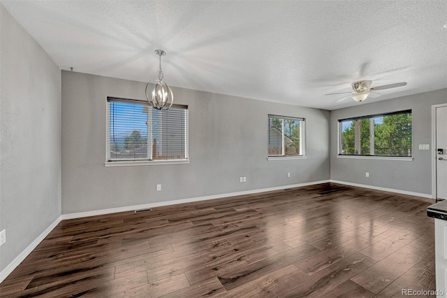 201 S Boundary St, Woodland Park, CO 80863 - empty room with a textured ceiling, a chandelier, dark wood-type flooring, and ceiling fan