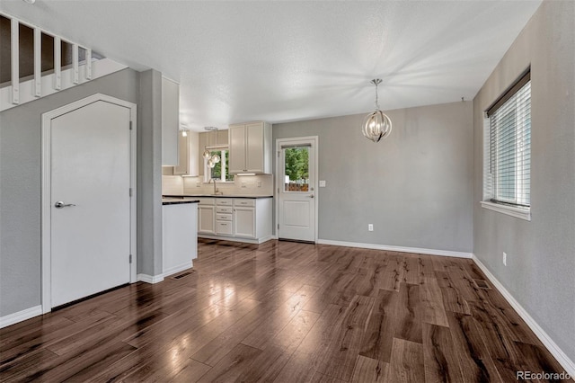 201 S Boundary St, Woodland Park, CO 80863 - unfurnished living room with dark wood finished floors and a chandelier