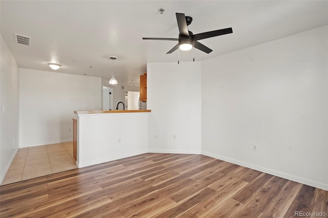 5425 County Road 32 Unit 14, Mead, CO 80504 - empty room with ceiling fan, wood finished floors, fire sprinkler in ceiling, and baseboards