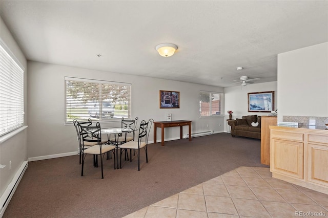 5425 County Road 32 Unit 14, Mead, CO 80504 - dining room featuring a baseboard heating unit, light carpet, a ceiling fan, and baseboards