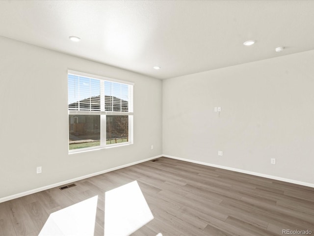 unfurnished room with hardwood / wood-style floors