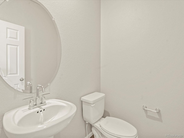 bathroom featuring sink and toilet