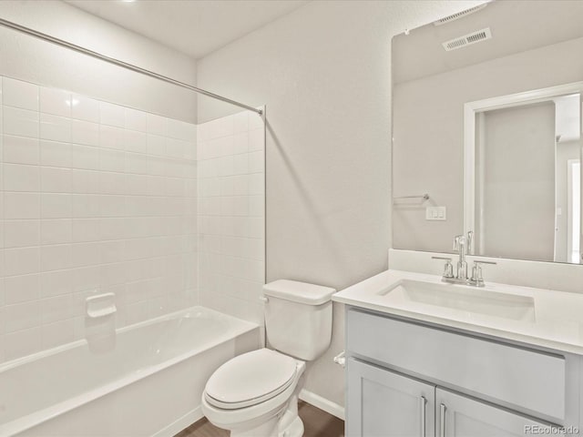 full bathroom featuring vanity, toilet, tiled shower / bath combo, and hardwood / wood-style floors