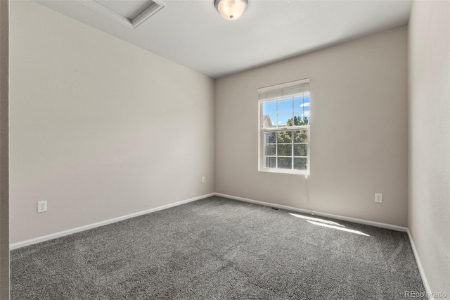 12778 Jasmine St Unit E, Thornton, CO 80602 - carpeted spare room featuring baseboards and attic access