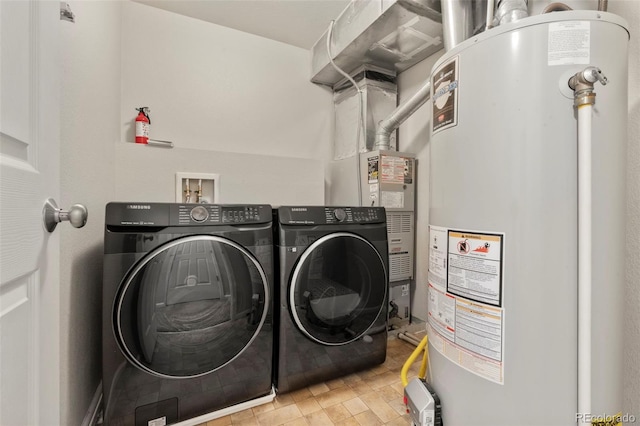 12778 Jasmine St Unit E, Thornton, CO 80602 - laundry room featuring gas water heater and washing machine and dryer