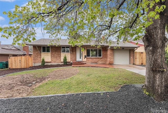 ranch-style house with an attached garage, concrete driveway, brick siding, and a gate