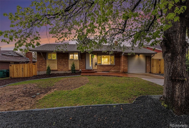 ranch-style house featuring concrete driveway, an attached garage, and brick siding