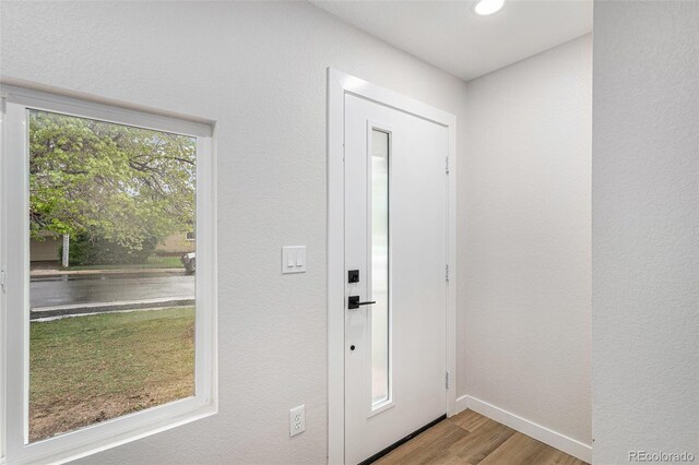 foyer entrance with wood finished floors, baseboards, and recessed lighting