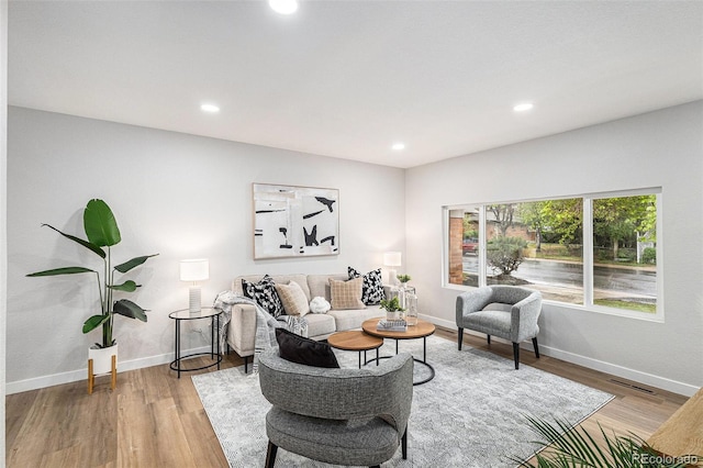 living area featuring wood finished floors, recessed lighting, and baseboards