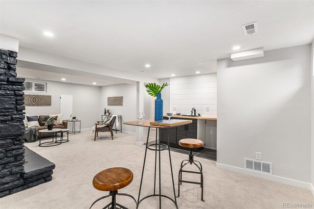 dining room with light colored carpet, recessed lighting, and baseboards