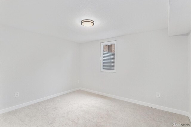 empty room with light carpet and baseboards