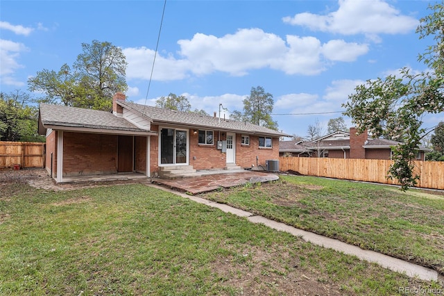 rear view of property featuring brick siding, a patio, central AC, and entry steps