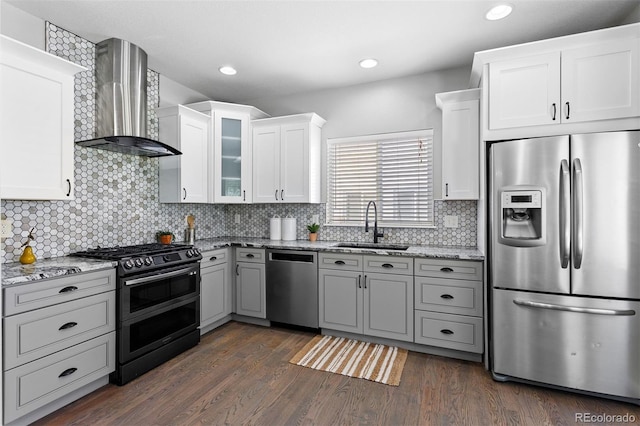 3775 Balderas St, Brighton, CO 80601 - kitchen featuring stainless steel appliances, wall chimney exhaust hood, light stone countertops, glass insert cabinets, and recessed lighting