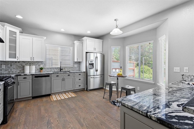 3775 Balderas St, Brighton, CO 80601 - kitchen featuring stainless steel appliances, backsplash, dark wood finished floors, stone counters, and recessed lighting