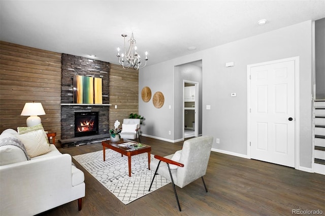 3775 Balderas St, Brighton, CO 80601 - living area featuring a chandelier, a stone fireplace, and dark wood-type flooring