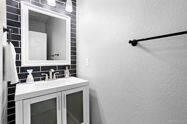 3775 Balderas St, Brighton, CO 80601 - bathroom featuring tasteful backsplash, vanity, and a textured wall