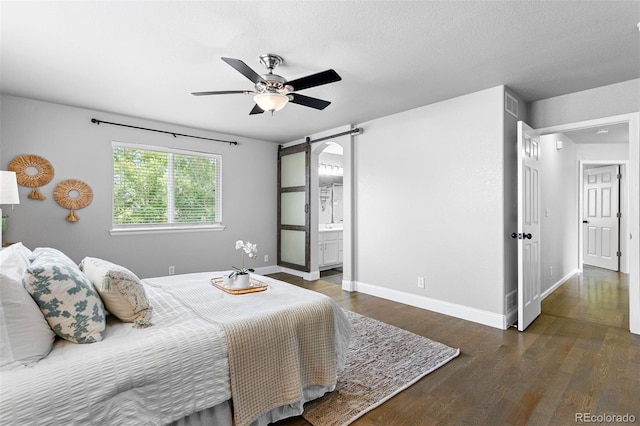 3775 Balderas St, Brighton, CO 80601 - bedroom with wood finished floors, a barn door, and ensuite bath