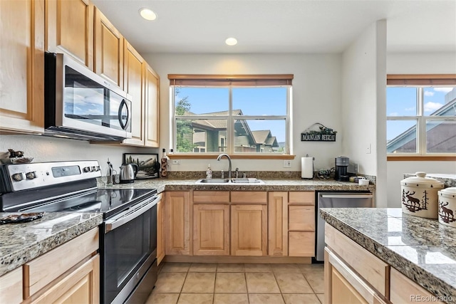 60 Black Diamond Trl Unit 60D, Silverthorne, CO 80498 - kitchen with appliances with stainless steel finishes, light tile patterned flooring, recessed lighting, light brown cabinets, and tile counters