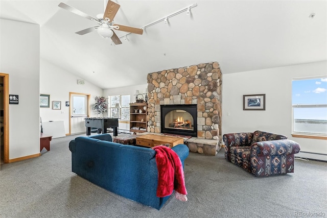 60 Black Diamond Trl Unit 60D, Silverthorne, CO 80498 - living area featuring vaulted ceiling, carpet floors, a stone fireplace, a ceiling fan, and rail lighting