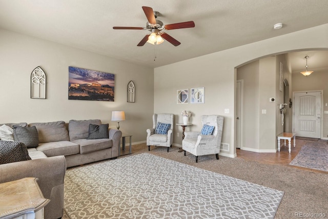 9233 Waters Edge Dr, Fountain, CO 80817 - carpeted living area featuring arched walkways and ceiling fan