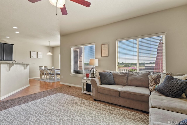 9233 Waters Edge Dr, Fountain, CO 80817 - living area featuring ceiling fan, light colored carpet, and recessed lighting